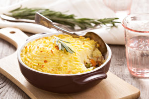 Dish of shepherds pie ready to be served on a cutting board