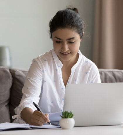 Woman doing Bible study with computer