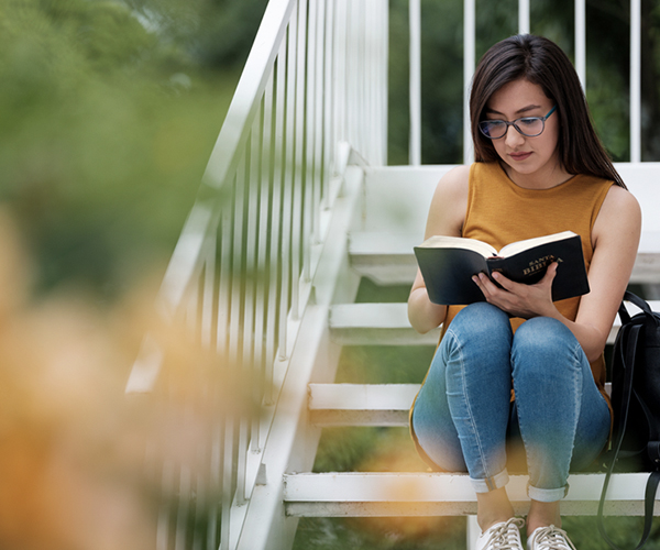 Woman reading the Gospels in the Bible