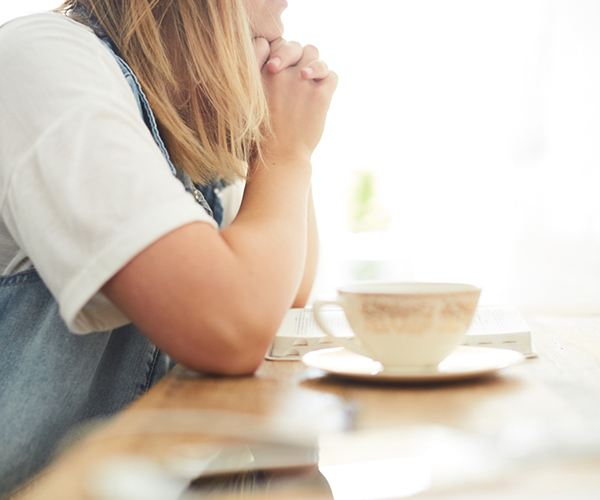woman praying for her small group