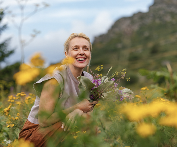 Hopeful woman in a field of yellow flowers