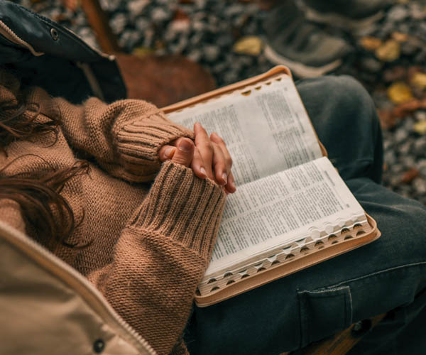 woman reading Bible to improve relationship with God